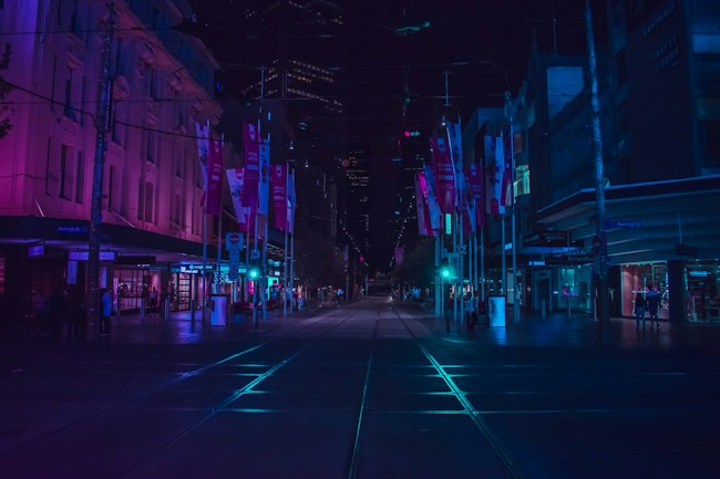 Cidade iluminada à noite, cenário de histórias e mistérios